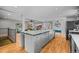 Modern kitchen with a large center island offering seating, stainless appliances, and an open layout to living spaces at 7209 S Sherman St, Centennial, CO 80122