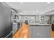 Well-appointed kitchen featuring gray cabinetry, stainless steel appliances, and open access to the dining area at 7209 S Sherman St, Centennial, CO 80122