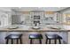 Bright kitchen featuring an expansive island with bar seating, modern finishes, and ample counter space at 7209 S Sherman St, Centennial, CO 80122