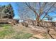 Fenced backyard features a patio area, mature trees, and potential for landscaping at 6707 S Elizabeth St, Centennial, CO 80122