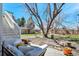 Relaxing backyard featuring a patio with comfortable outdoor furniture and a mature tree providing ample shade on a sunny day at 6707 S Elizabeth St, Centennial, CO 80122