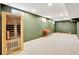 Basement with a personal sauna, neutral carpet, olive green accent wall, and recessed lighting at 6707 S Elizabeth St, Centennial, CO 80122