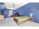 Spacious bedroom featuring blue walls, carpet, dormer windows, and a cozy reading nook at 6707 S Elizabeth St, Centennial, CO 80122