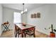 Charming dining room featuring a wooden table, decorative wall shelves, and natural light at 6707 S Elizabeth St, Centennial, CO 80122