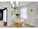 Cozy dining area with modern chandelier, wooden table, and natural light at 6707 S Elizabeth St, Centennial, CO 80122