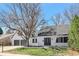 Charming home featuring a well-maintained lawn, mature trees, and a two-car garage at 6707 S Elizabeth St, Centennial, CO 80122