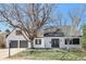 Charming home featuring a well-maintained lawn, mature trees, and a two-car garage at 6707 S Elizabeth St, Centennial, CO 80122