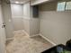 Unfinished basement space with tiled floors and access to the laundry area at 6895 W 84Th Way # 4, Arvada, CO 80003