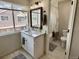 Bathroom featuring a vanity with a marble countertop, large window, and modern fixtures at 6895 W 84Th Way # 4, Arvada, CO 80003