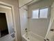 Bathroom with a tiled shower and tub combo, window, and modern fixtures at 6895 W 84Th Way # 4, Arvada, CO 80003