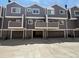 Exterior view of townhome building with multiple garage parking spaces at 6895 W 84Th Way # 4, Arvada, CO 80003