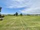 Scenic view of the expansive golf course, with lush green fairways and mature trees under a bright, partly cloudy sky at 6895 W 84Th Way # 4, Arvada, CO 80003