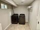 Spacious laundry room with modern, front-loading washer and dryer units, and tile flooring at 6895 W 84Th Way # 4, Arvada, CO 80003