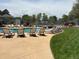 Community pool area with lounge chairs and grassy surroundings at 6895 W 84Th Way # 4, Arvada, CO 80003