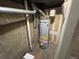 Water heater located in utility area, surrounded by plumbing and utility connections within a concrete enclosed space at 6895 W 84Th Way # 4, Arvada, CO 80003