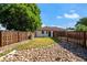 Well-kept backyard with manicured grass, a stone garden, and a wooden fence that encloses the property at 5090 W 36Th Ave, Denver, CO 80212