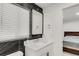 Modern bathroom featuring a dark stone accent wall, mirror, and white vanity at 5090 W 36Th Ave, Denver, CO 80212