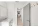 Bright bathroom with single vanity and marble countertop, leading to the hall at 5090 W 36Th Ave, Denver, CO 80212