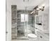 Sleek bathroom with a glass shower, gray tiled walls, and modern fixtures at 5090 W 36Th Ave, Denver, CO 80212