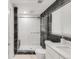 Updated bathroom featuring a glass shower with subway tile and dark stone accents at 5090 W 36Th Ave, Denver, CO 80212
