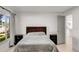 Bedroom featuring a full bed with two side tables, light floors, and a large window at 5090 W 36Th Ave, Denver, CO 80212