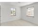 Bright bedroom with neutral walls, two windows, and light hardwood floors at 5090 W 36Th Ave, Denver, CO 80212