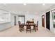Well-lit dining room featuring hardwood floors, modern decor, and a view into the updated kitchen at 5090 W 36Th Ave, Denver, CO 80212
