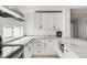 Modern kitchen with white cabinets, marble countertops, and stainless steel KitchenAid appliances at 5090 W 36Th Ave, Denver, CO 80212
