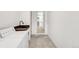 Bright laundry room features a sink with a wooden countertop, white cabinetry, and a modern, black faucet at 5090 W 36Th Ave, Denver, CO 80212