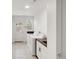 Cozy laundry area has a white brick accent wall and modern washer and dryer with wooden countertops at 5090 W 36Th Ave, Denver, CO 80212