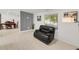 Bright living room featuring hardwood floors, a black leather chair, and a modern design at 5090 W 36Th Ave, Denver, CO 80212