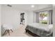 Bedroom featuring ensuite bathroom, light hardwood floors, and a gray comforter at 5090 W 36Th Ave, Denver, CO 80212