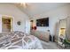 Comfortable bedroom featuring carpet flooring, a dresser, and a large television on the wall at 529 Gallegos Cir, Erie, CO 80516
