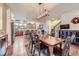 Spacious dining room and kitchen showcasing an open-concept layout with hardwood floors at 529 Gallegos Cir, Erie, CO 80516