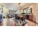 Open-concept dining area with wooden floors and contemporary lighting fixture at 529 Gallegos Cir, Erie, CO 80516