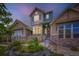 Charming two-story home with a stone facade, blooming flowers, and a welcoming front porch at 529 Gallegos Cir, Erie, CO 80516