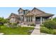 Well-maintained home exterior with lush front lawn and stone accents at 529 Gallegos Cir, Erie, CO 80516