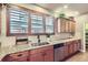 Bright kitchen featuring granite countertops, stainless steel appliances, and wooden cabinets at 529 Gallegos Cir, Erie, CO 80516