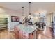 Open-concept kitchen island with granite countertop, connecting to the dining and living areas at 529 Gallegos Cir, Erie, CO 80516