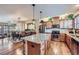 Open kitchen with stainless appliances, granite countertops, and hardwood floors that flows into the dining room at 529 Gallegos Cir, Erie, CO 80516