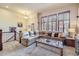 Comfortable living room with neutral carpet and large windows with wooden shutters at 529 Gallegos Cir, Erie, CO 80516