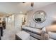 Cozy sitting room with comfortable sofa, mirror, and access to the hallway and en-suite bathroom at 529 Gallegos Cir, Erie, CO 80516