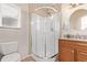 Clean bathroom with a large shower and wood vanity at 257 Wadsworth Cir, Longmont, CO 80504