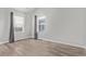 Bright bedroom with two windows, gray curtains, and wood-look flooring at 257 Wadsworth Cir, Longmont, CO 80504