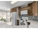 Modern kitchen with white appliances and wood cabinets at 257 Wadsworth Cir, Longmont, CO 80504