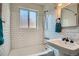 Bathroom featuring white subway tile, pedestal sink, and classic fixtures at 1523 Ivy St # 6, Denver, CO 80220