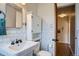 Bathroom featuring white subway tile, pedestal sink, built-in cabinet, and classic fixtures at 1523 Ivy St # 6, Denver, CO 80220