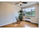 Bedroom featuring hardwood floors, neutral walls, ceiling fan, and a rocking chair at 1523 Ivy St # 6, Denver, CO 80220