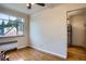 Bedroom with hardwood floors, neutral walls, and a view into the adjacent room at 1523 Ivy St # 6, Denver, CO 80220