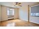 Bedroom featuring hardwood floors, neutral walls, ceiling fan, and bright windows at 1523 Ivy St # 6, Denver, CO 80220